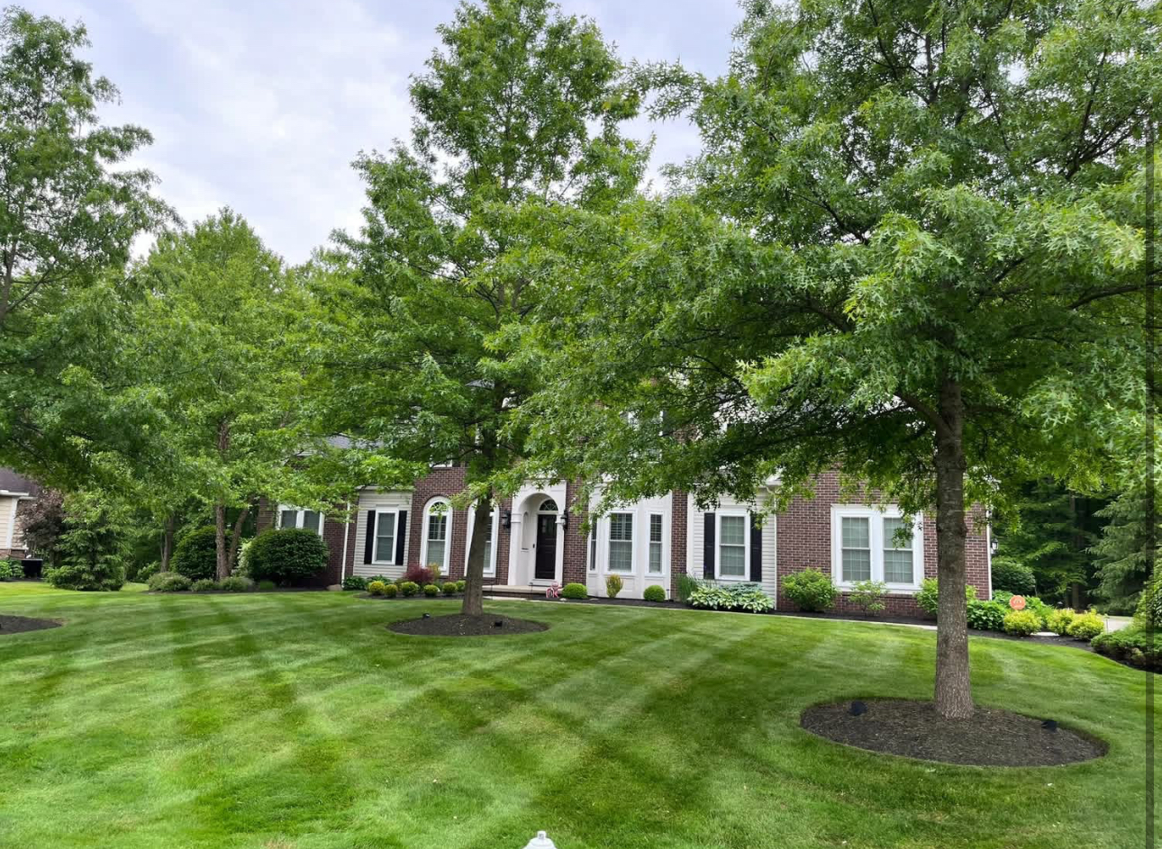 Brick home with mature trees and a perfectly maintained lawn in Chagrin Falls, Ohio
