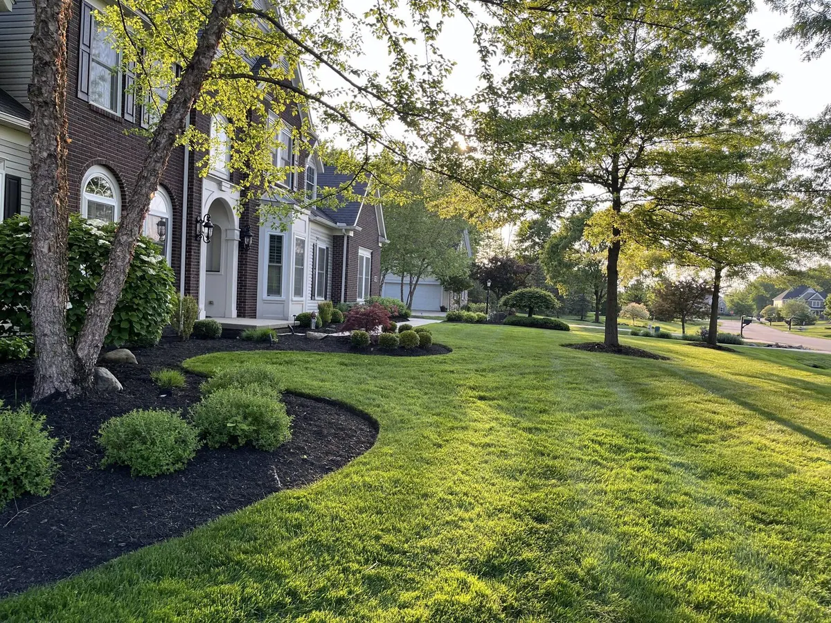 Stone-front home with mulched curve bed