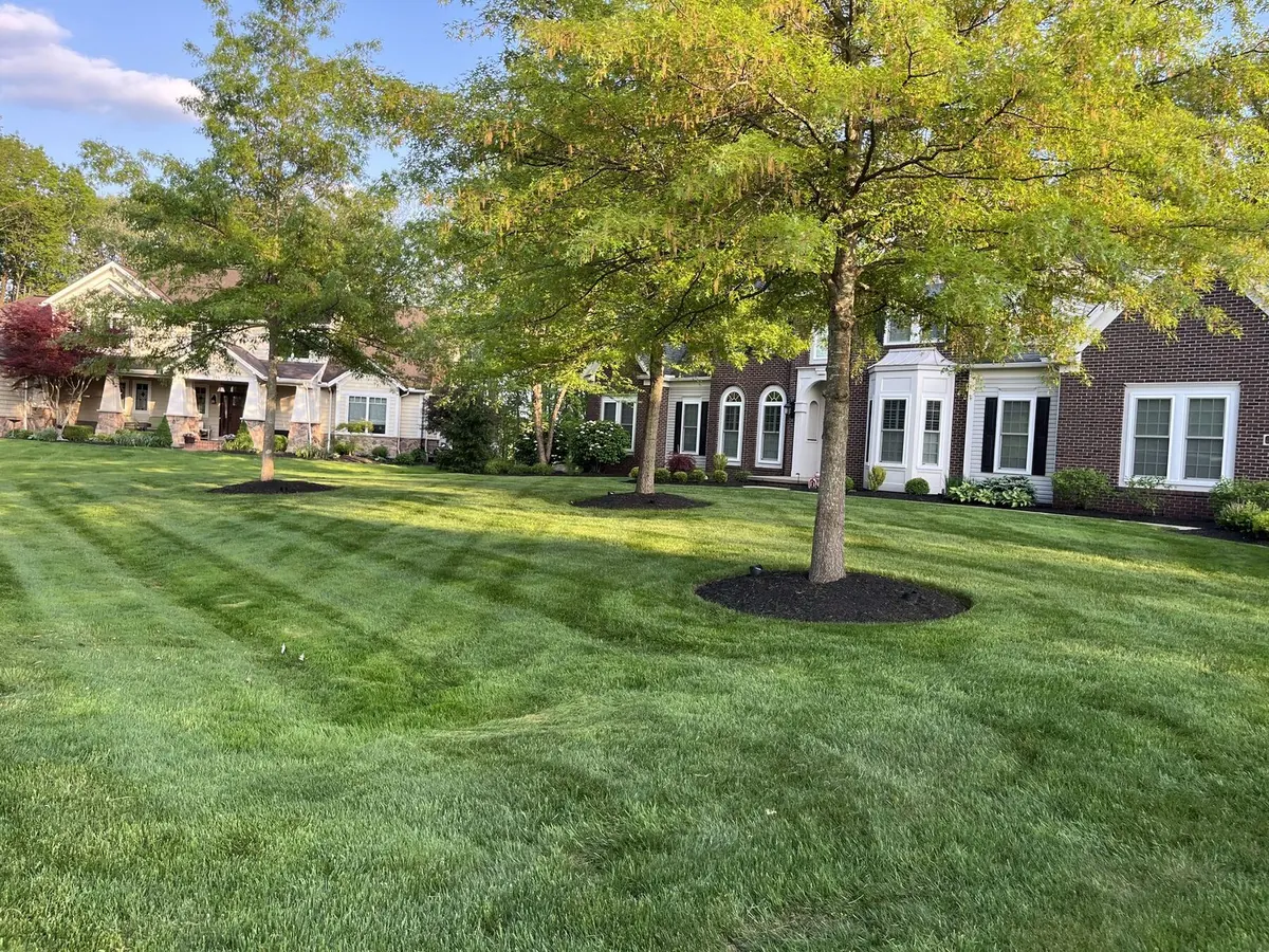 Lush lawn and bed work at stone home
