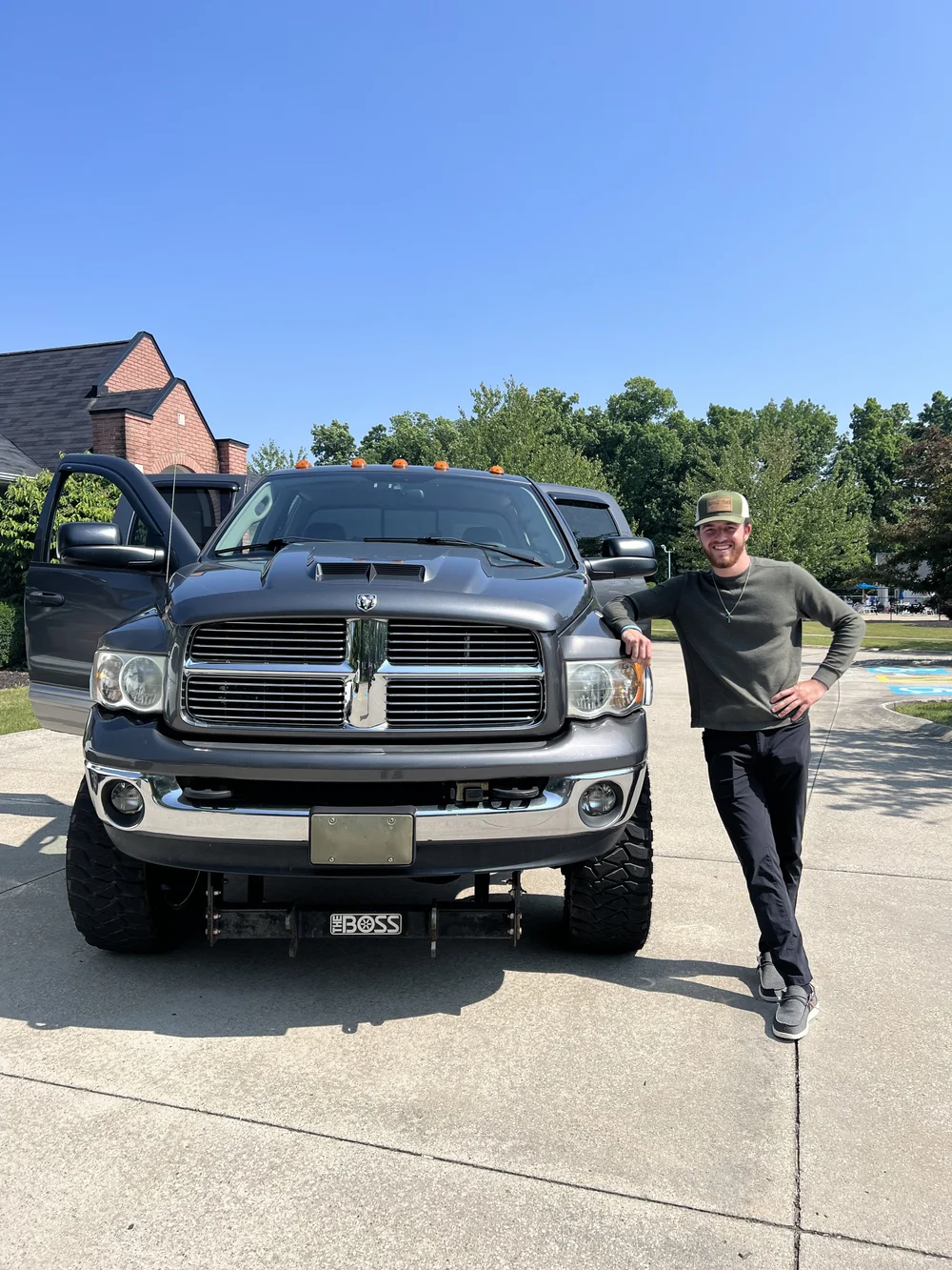 Nathan Meyer, owner of Eagle Scapes, standing with his work truck in Aurora, Ohio